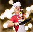 portrait of young cook man cooking vegetables against a abstract portrait of young cook man cooking vegetables against a abstract