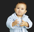 portrait of adorable infant with blue bathrobe holding a glass o portrait of adorable infant with blue bathrobe holding a glass o