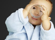portrait of adorable infant with blue bathrobe drinking water ov