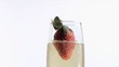 Strawberry diving into champagne in super slow motion