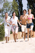 Friends running on sand