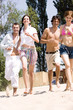 Friends running on sand