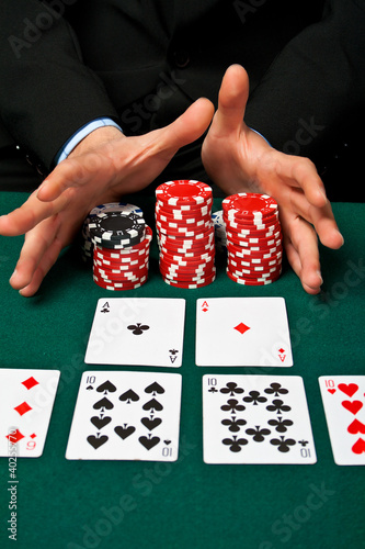Photo: Gambler with cards and chips. Gambler with cards and chips.