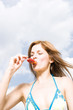 Young woman eating candy, close-up