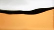 Orange liquid rippling in super slow motion