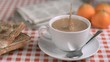 Coffee with milk in super slow motion receiving sugar