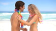 Couple putting flower necklace to each other