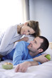 Young couple in bed, looking at each other, smiling
