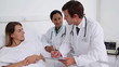 Doctors talking with a female patient