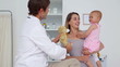 Doctor showing a teddy bear to a baby