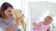 Baby girl kissing her teddy bear