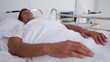 Unconscious patient lying in a sickbed
