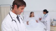 Doctor writing on a file in a patient's room
