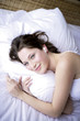 Young woman listening MP3, smiling, portrait