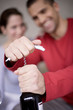 Young man opening wine bottle