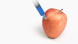 Syringe in super slow motion falling on an apple