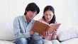 Man and a woman reading a book together