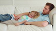Son lies with his father as they sleep