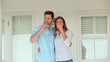 Man and a woman clinking glasses of champagne before holding each other