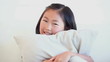 Girl sitting on the couch with a pillow