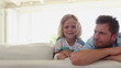 Family appearing from behind a couch one after another