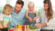 Family working together to prepare a salad