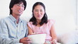 Couple eating popcorn together