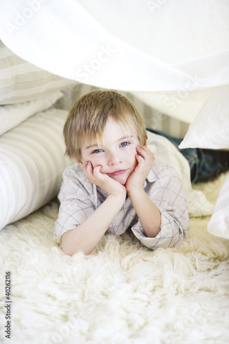 Photo: Boy lying on carpet, portrait Boy lying on carpet, portrait