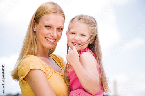 Photo: Mother with daughter, smiling Mother with daughter, smiling