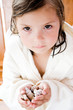 Girl holding shells, close-up