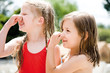 Girls holding nose, side view