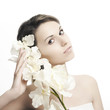beautiful woman with perfect skin and a white orchid