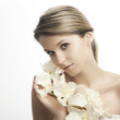Photo: beautiful woman with perfect skin and a white orchid beautiful woman with perfect skin and a white orchid