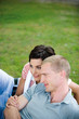 Young couple lying on grass, smiling