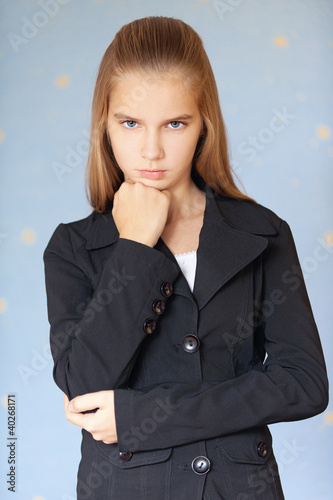 Photo: Serious girl-teenager in business suit Serious girl-teenager in business suit