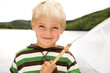 Boy holding fishing net, smiling, portrait