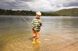 Boy holding fishing net in water