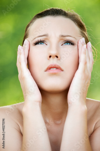 Photo: Young woman keeps hands for head Young woman keeps hands for head