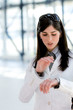 Young woman looking at wristwatch