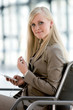 Young woman holding mobile phone, portrait