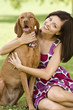 Young woman with dog, smiling