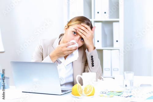 Photo: People with cold and flu at work place People with cold and flu at work place
