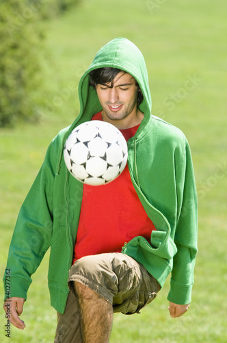 Photo: Young man playing Keepy Uppy Young man playing Keepy Uppy