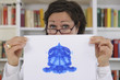Psychotherapist holding Rorschach Test