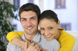 Happy couple in love hugging at home