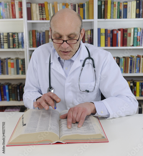 Photo: Doctor looking up information on medicine Doctor looking up information on medicine