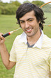 Young man holding badminton racquet, portrait