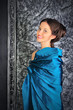 beautiful young brunette in blue vintage dress