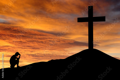 Photo: Silhouette of a man sitting regretting his sins Silhouette of a man sitting regretting his sins