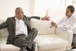 Mid adult man persuading mature man